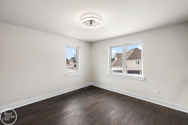 unfurnished room with wood-type flooring