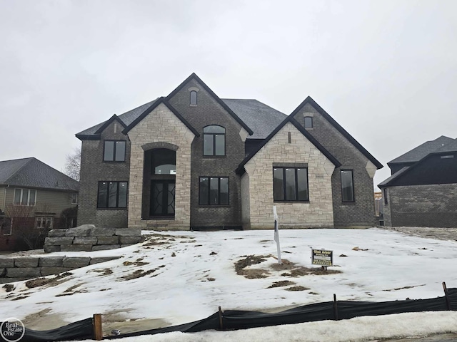 french country inspired facade with brick siding