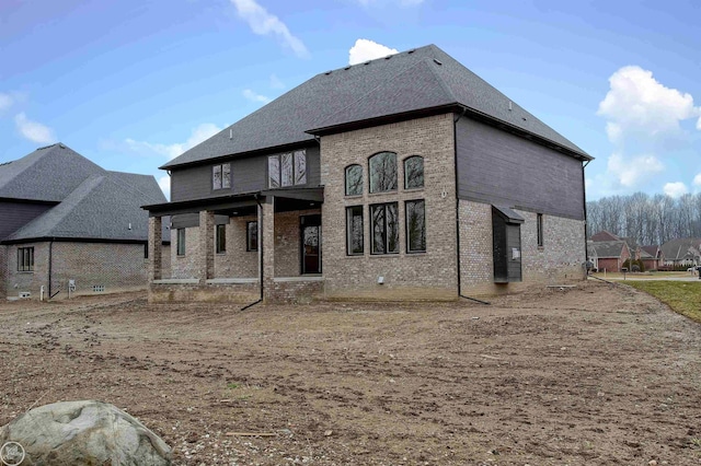 back of property featuring brick siding