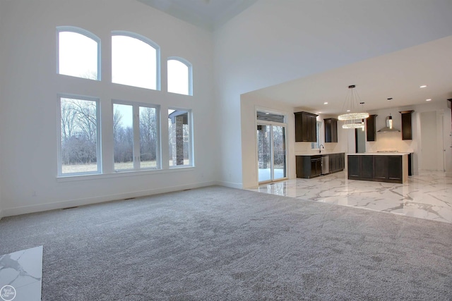 unfurnished living room featuring a high ceiling