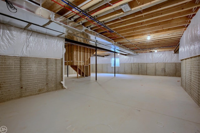 basement featuring brick wall