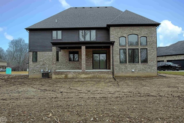 rear view of property with central air condition unit