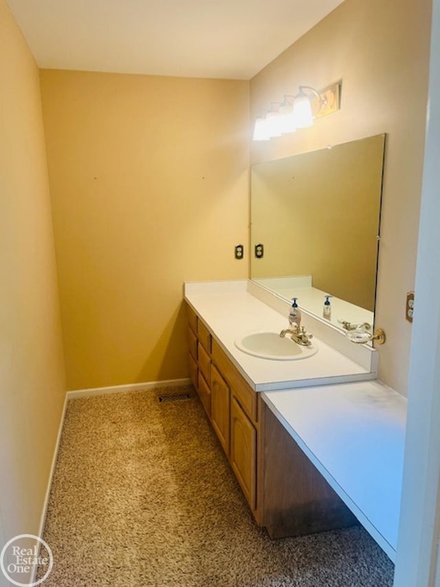 bathroom featuring baseboards and vanity