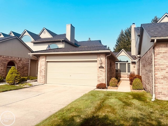 view of front facade featuring brick siding, concrete driveway, a garage, and a front yard