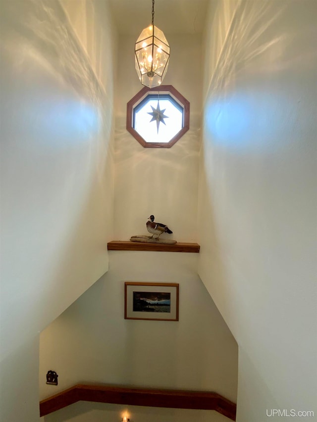 staircase featuring a chandelier