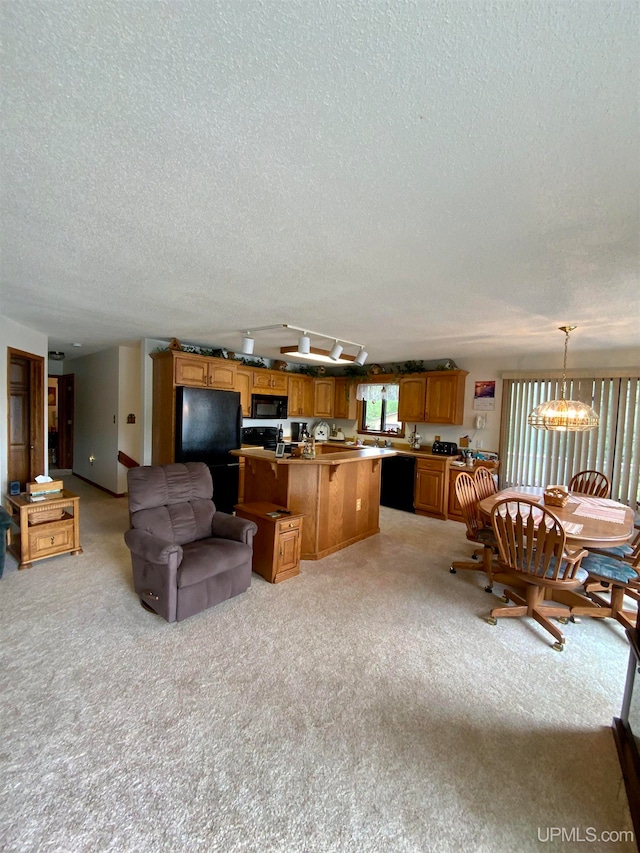 carpeted living room featuring a notable chandelier and a textured ceiling