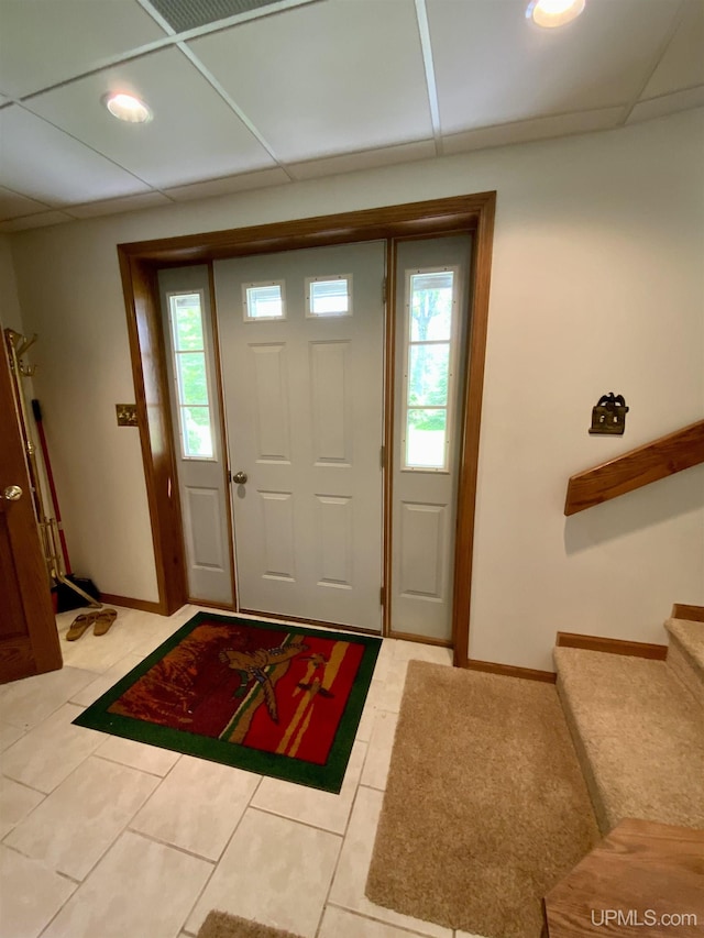 foyer featuring light tile patterned floors and baseboards
