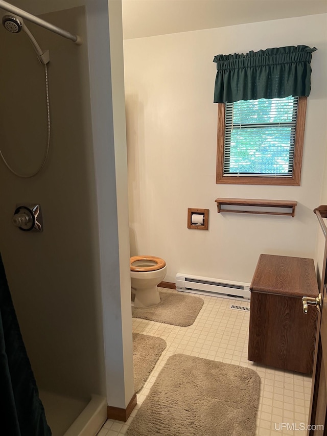 full bathroom featuring tile patterned flooring, toilet, baseboards, a baseboard heating unit, and a shower stall