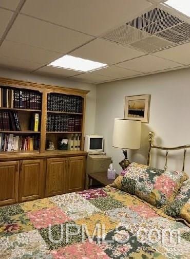 bedroom with a paneled ceiling