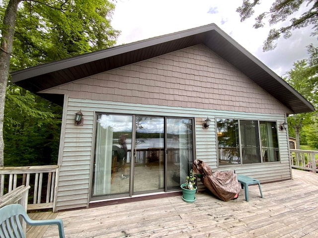 rear view of property featuring a wooden deck