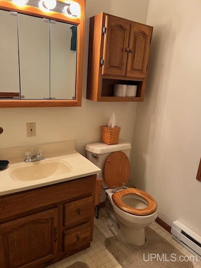 bathroom featuring vanity, toilet, tile patterned floors, and a baseboard radiator