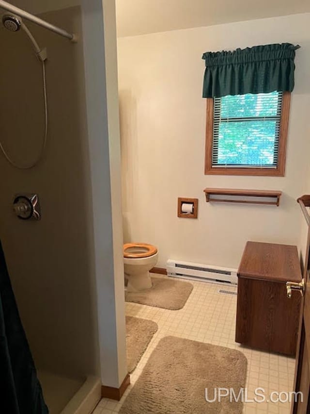 bathroom featuring toilet, a baseboard heating unit, and a shower