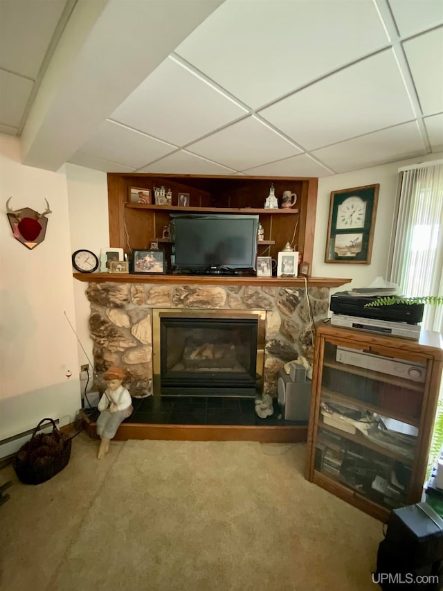 unfurnished room with a fireplace and a paneled ceiling