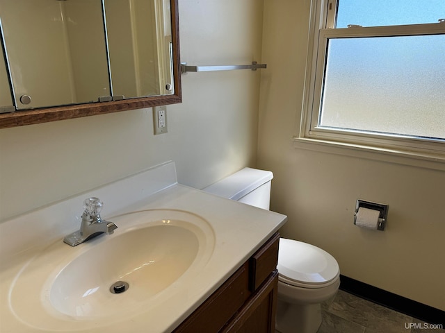 bathroom with vanity, toilet, and tile patterned flooring