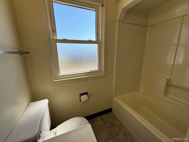 bathroom featuring tile patterned flooring, toilet, and shower / washtub combination