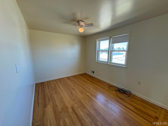 empty room featuring ceiling fan and light wood-type flooring