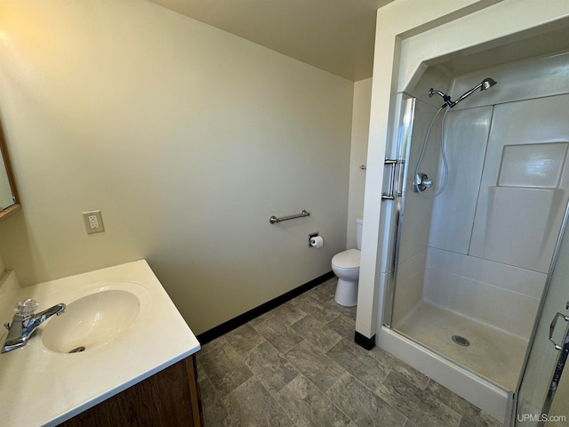 bathroom with tile patterned flooring, a shower with shower door, toilet, and vanity