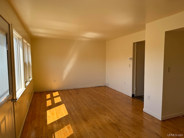 spare room featuring hardwood / wood-style flooring and a wealth of natural light