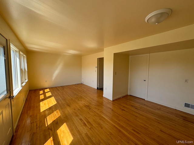 spare room with hardwood / wood-style floors