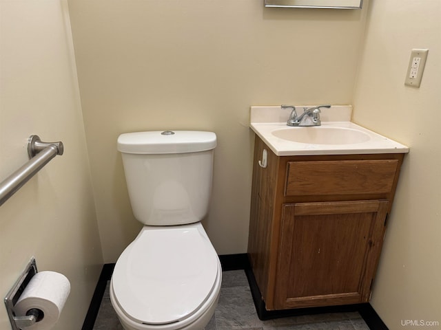 bathroom featuring tile patterned floors, toilet, and vanity