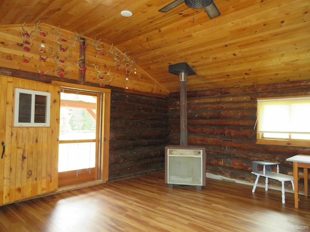 empty room featuring log walls, hardwood / wood-style flooring, and wood ceiling