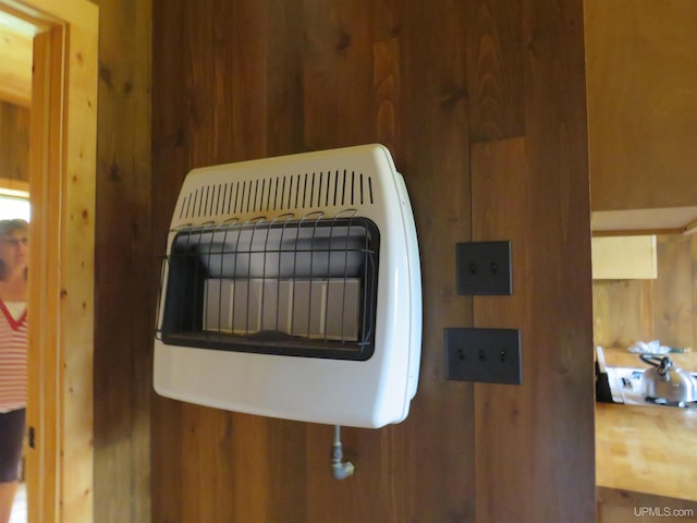 details featuring wooden walls and heating unit