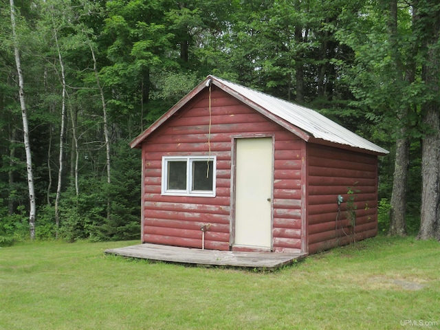 view of outbuilding featuring a lawn