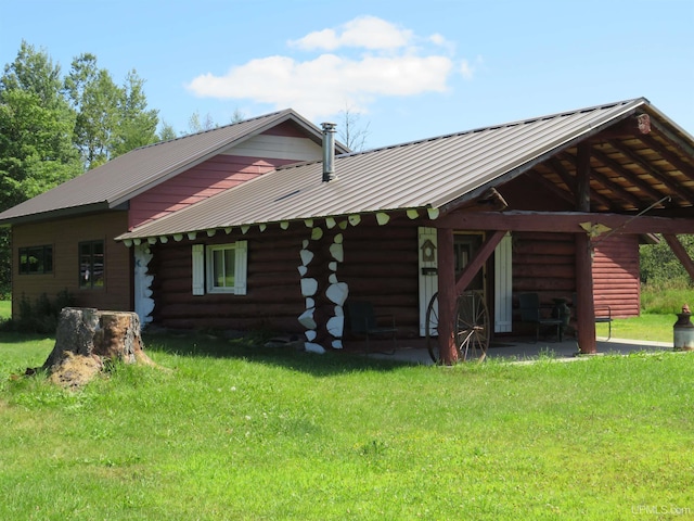 back of house with a lawn