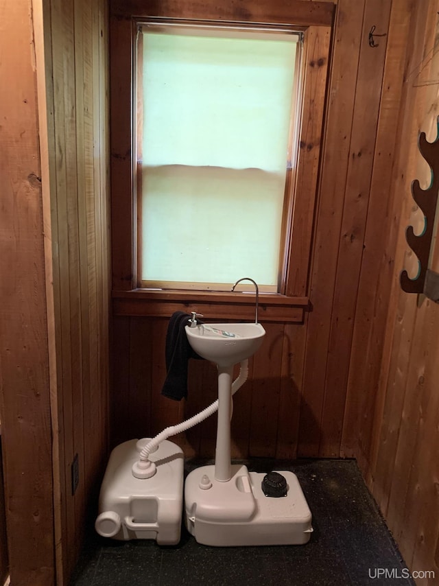 bathroom featuring wooden walls