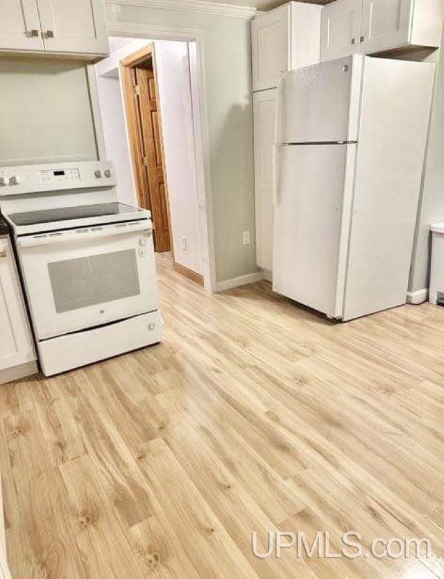 kitchen featuring white cabinetry, light hardwood / wood-style flooring, and white appliances