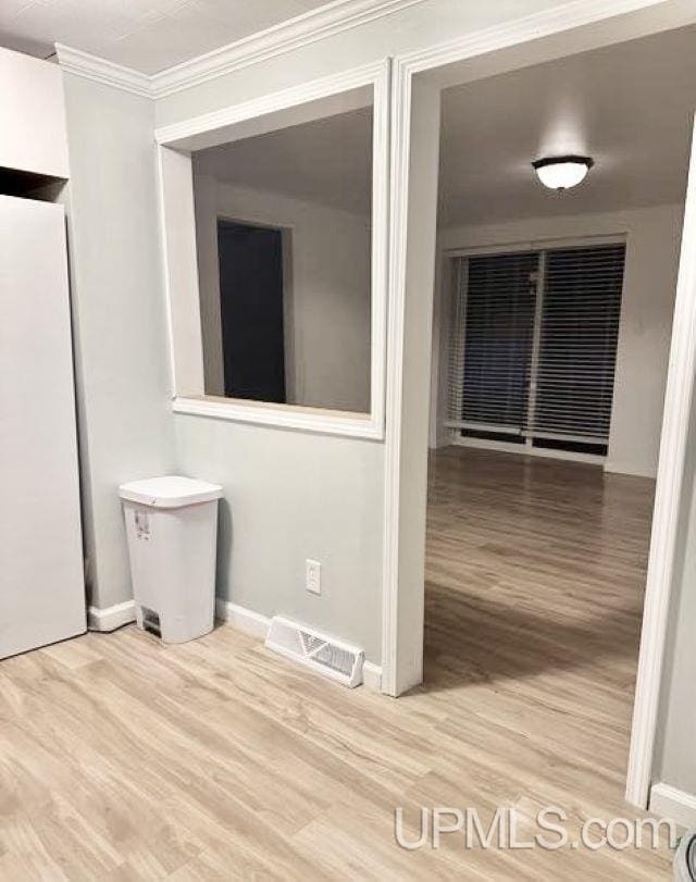 interior space featuring hardwood / wood-style flooring and ornamental molding