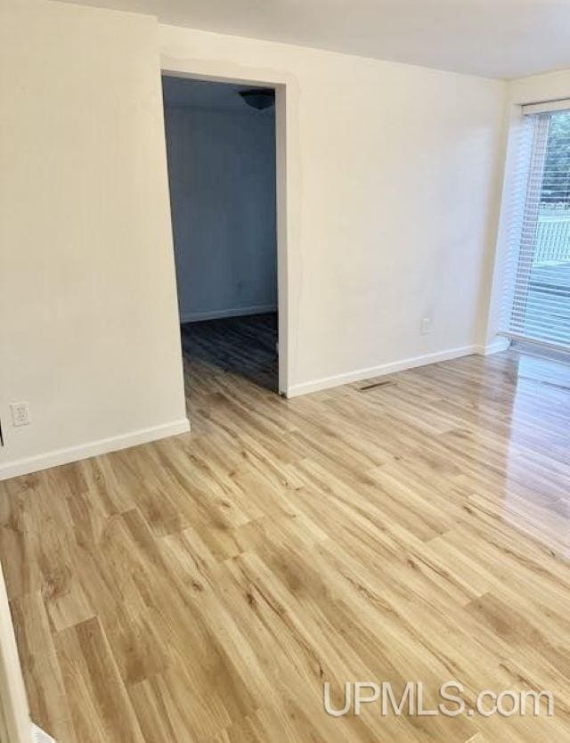 unfurnished room featuring light wood-type flooring