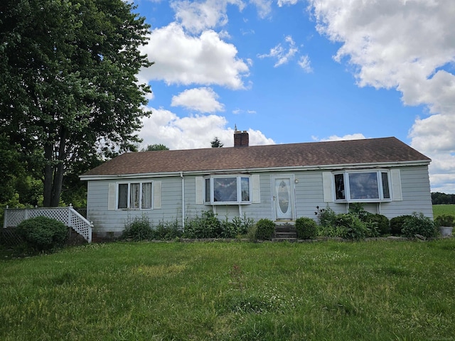 ranch-style home with crawl space, a chimney, and a front yard