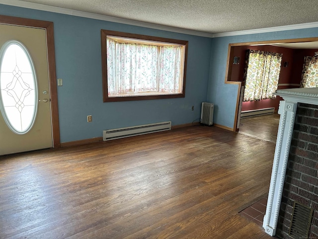 foyer with radiator, wood finished floors, and a baseboard radiator