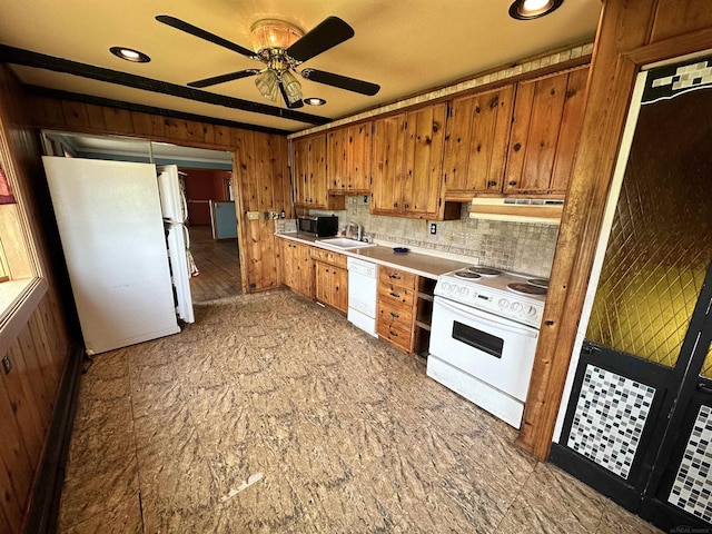 kitchen featuring white appliances, ventilation hood, a sink, light countertops, and brown cabinets