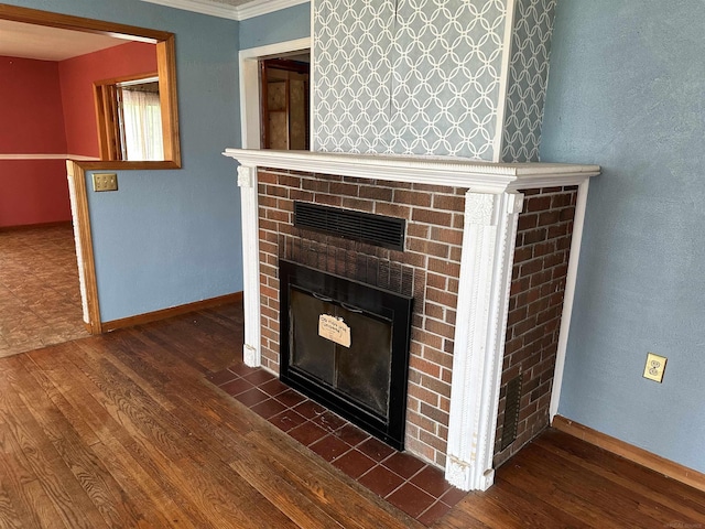 details with a brick fireplace, wood finished floors, baseboards, and ornamental molding