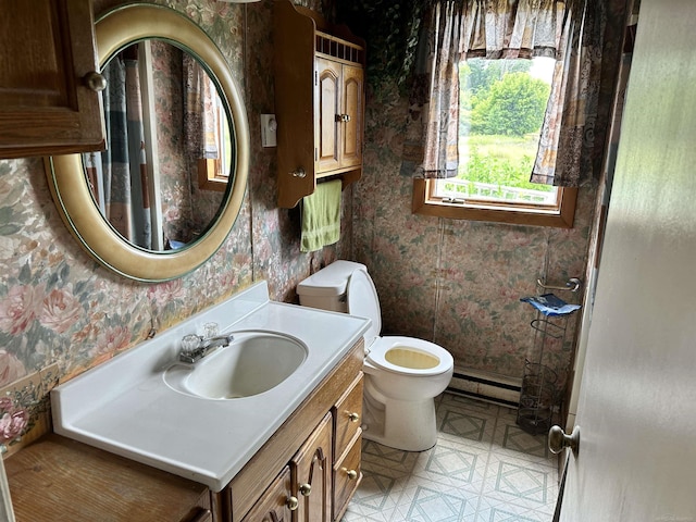 bathroom featuring wallpapered walls, toilet, vanity, and baseboard heating