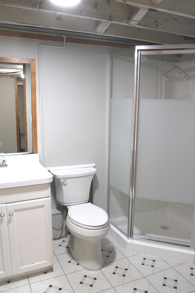 bathroom with tile patterned flooring, a shower with shower door, toilet, and vanity