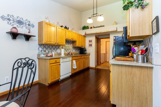 kitchen featuring white dishwasher, hanging light fixtures, backsplash, dark hardwood / wood-style floors, and a towering ceiling