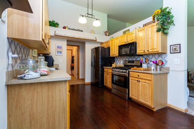 kitchen with stainless steel gas range, hanging light fixtures, decorative backsplash, fridge with ice dispenser, and dark wood-type flooring