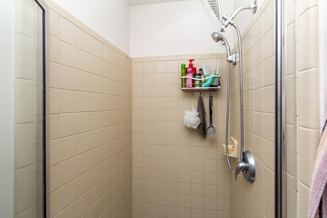 bathroom with a shower with shower door