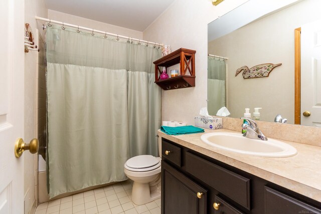 bathroom featuring vanity, tile patterned flooring, and toilet