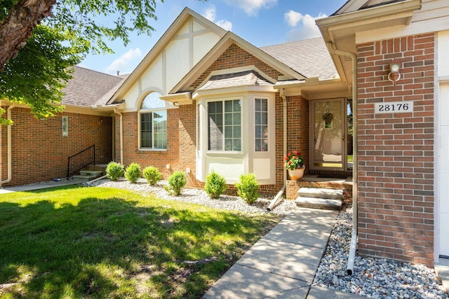 view of exterior entry featuring a yard