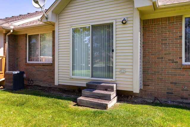 exterior space featuring a yard and central AC unit