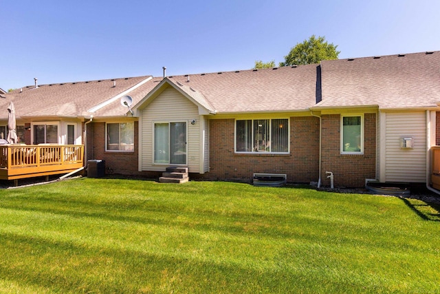 rear view of property featuring central AC, a yard, and a wooden deck