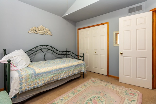 bedroom featuring light carpet and a closet