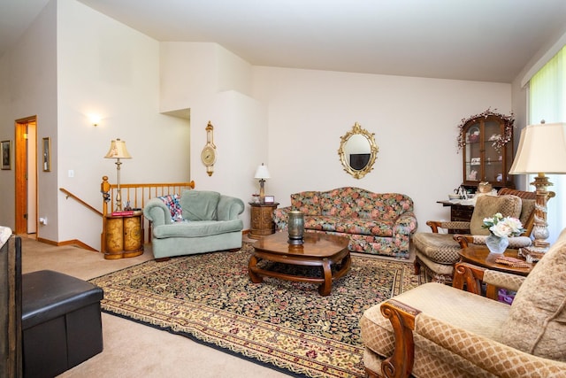 living room featuring carpet flooring and high vaulted ceiling