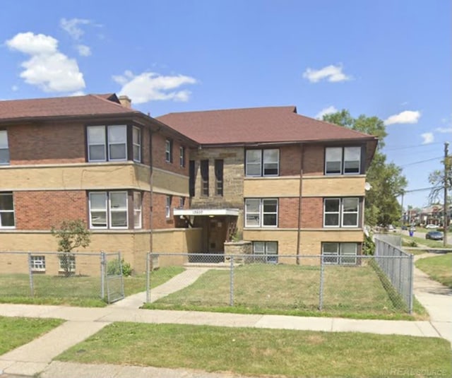 view of building exterior with a fenced front yard