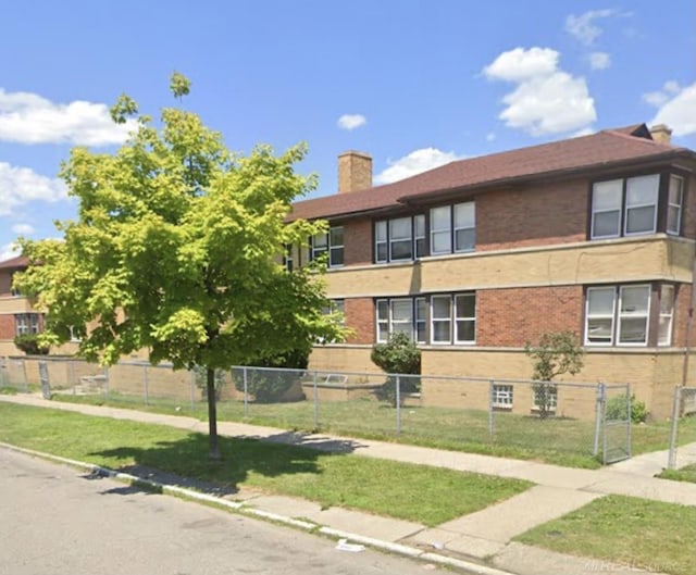 view of building exterior featuring a fenced front yard