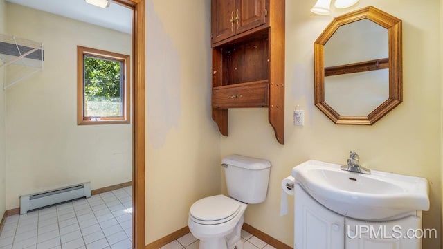 bathroom with vanity, a baseboard heating unit, toilet, and tile patterned floors